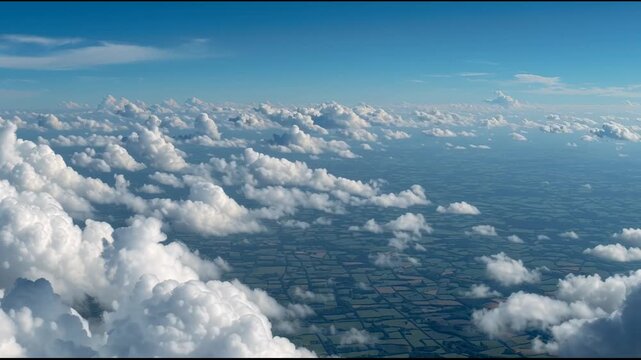 A mesmerizing aerial view above a flowing sea of undulating white cumulus clouds, revealing the patchwork landscape below