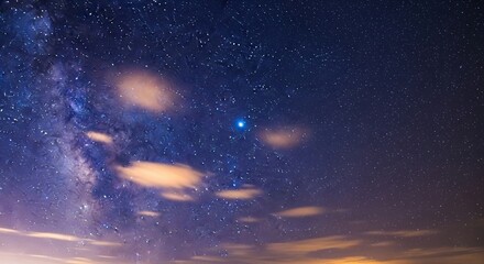 Obraz premium Astrophotography of a stunning night sky, featuring the faint glow of the Milky Way, scattered stars, and a single, intensely bright blue star. Wispy clouds are subtly lit by a warm glow from below th
