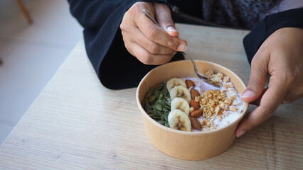 Delicious yogurt bowl with fruit and nuts for breakfast