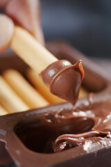 Enjoying a tasty treat with chocolate dip and wafer sticks