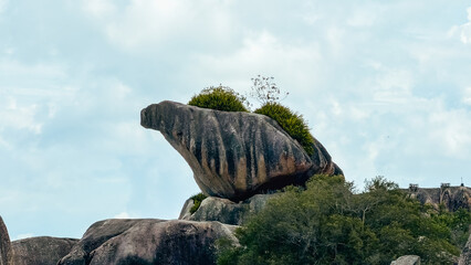 Iconic granite turtle rock formation against cloudy sky close up