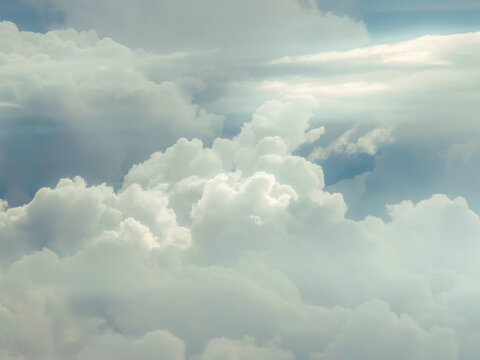 Bright white cumulus clouds layered against blue sky sun rays