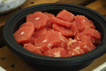 Freshly cut watermelon slices in a bowl at a market