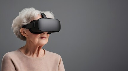 Elderly woman with gray hair wearing a virtual reality headset looking forward against a neutral gray background