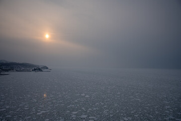Utoro Port in Shiretoko Surrounded by Drift Ice and Sunset Glow in Winter © warapin