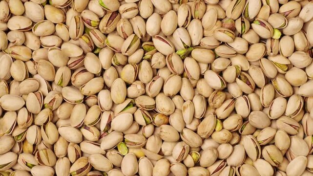Salted roasted pistachio nuts moving background