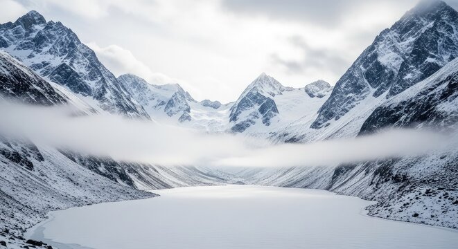 Majestic snow-capped mountains shrouded in ethereal mist above a frozen, serene alpine lake creating a breathtaking winter wonderland scene of unparalleled natural beauty and tranquility - Powered by Adobe