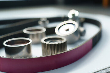 Close-up of a new car timing belt kit, including a pulley and idler roller. Automotive spare parts...