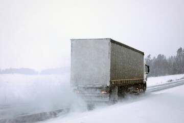 Semi Truck Driving on Snowy Road. Challenging Driving Conditions. 
