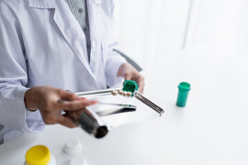 Woman pharmacist Working and Arranging Medications
counting and arrange pills on stainless counting tray with spatula in pharmacy.