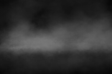 Abstract black background with textured grey fog, smoky mist, or steam effect, creating a...