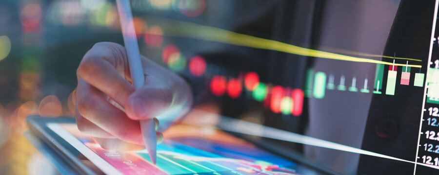 Analyzing financial data on a tablet with a stylus, modern business concept