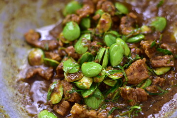 Spicy stir fried pork with Cluster Bean (Bitter Bean or stink beans) popular southern Thai food, Stir fried Stinky Bean in Chili Paste with Pork