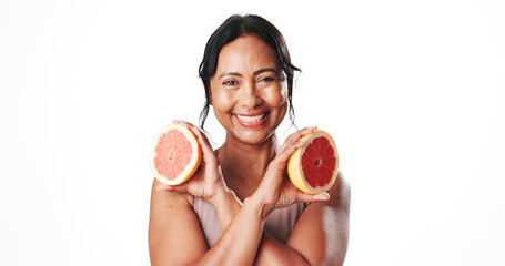 Skincare, portrait and woman with grapefruit, self care and facial treatment with vitamin c and glow. White background, natural cosmetics and mature person with fruit, anti aging benefits and studio