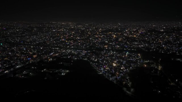 Aerial night footage of Kathmandu city during Diwali (Tihar), featuring the illuminated Dharahara Tower and glowing skyline filled with festive lights, showing Nepal&rsquo;s vibrant cultural celebration.