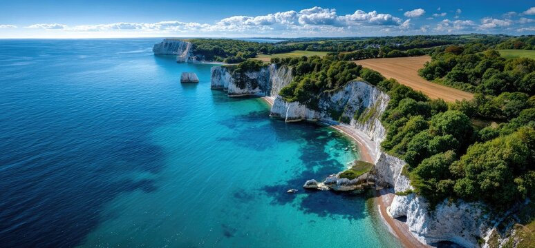 an aerial view of old jewel island, dorset, in the magnificent british countryside, overlooking an endless sea with white cliffs and green grass on top of them - Powered by Adobe