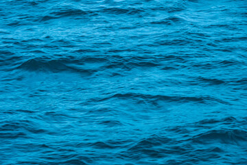 Deep sea waves. The surface of the blue sea has ripples and light reflecting on the sea.