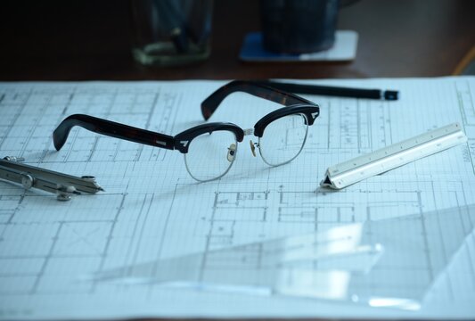 建築士の製図机に置かれた眼鏡と製図道具
Architect’s drafting desk with glasses and drawing tools