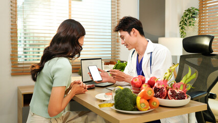 Dietician, male nutrition specialist consulting woman, developing healthy diet, dietary program. Dietary consultant asking, giving male patient advice, help, nutritional information, new meal plan