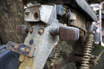 Close up detail of an old vintage rusty motorcycle rear part. This forgotten, abandoned classic retro bike shows signs of decay and weathering over long time
