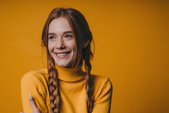 happy woman with twin braids, cheerful teacherlooking woman with twin braids and warm expression