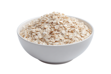 White bowl filled with rolled oats on a black background cereal grain