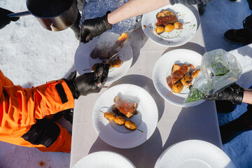 A professional chef prepares and serves a gourmet dish in a restaurant kitchen. This is the final stage of preparation, requiring precise teamwork.