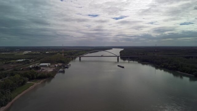 Aerial view of the surrounding towns and landscape of the Pentele Bridge over the Danube River on a cloudy day at Dunavecse, Hungary.