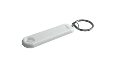 White elongated key fob on keyring, isolated on black backdrop