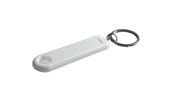 White elongated key fob on keyring, isolated on black backdrop