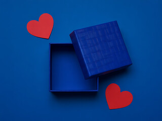 Open blue gift box with floating red hearts on vibrant blue background