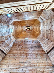 Obraz premium A view up to the bell tower of the ancient wooden church of the Cossacks of the Zaporizhian army in the Sich.