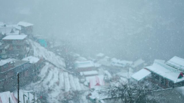 4K Closeup shot of snowfall in front of Sangla village during a winter storm at Sangla in Kinnaur district, Himachal Pradesh, India. Scenic view of snowfall in winter season. Winter snow background.