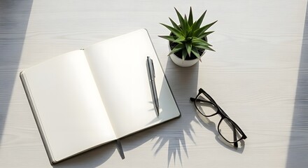 Blank notebook and pen on a sunlit white wooden desk with glasses and a plant, a serene setup for journaling,planning, or creative writing