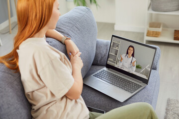 Sick young girl listening recommendations and appointment having online video call with a female...