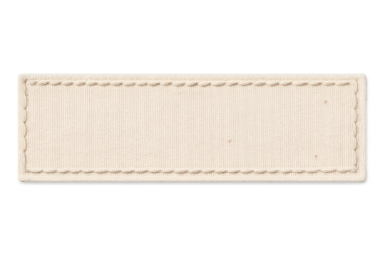 Blank beige fabric tag in rectangle shape, stitched border, empty textile label for clothing branding