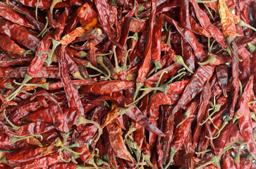 Dried Red Chili Peppers Background: Fiery Hot Spice Texture, Asian and Mexican Cuisine Ingredient for Cooking, Flavoring, and Wallpaper