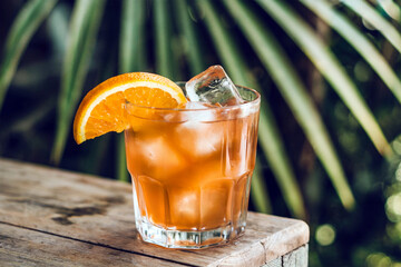 Refreshing Orange Cocktail with Ice Tropical Summer Drink on Wooden Table