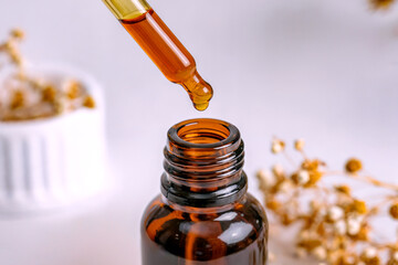 Amber Glass Dropper Bottle with Herbal Oil Natural Organic Skincare Essence Concept