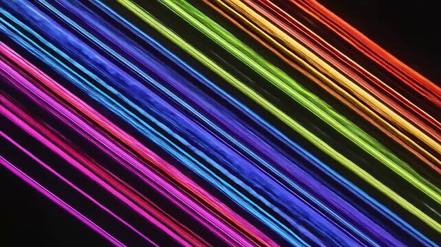 Vibrant rainbow light streaks dancing across a dark backdrop creating a dynamic and colorful abstract motion graphic ideal for modern designs