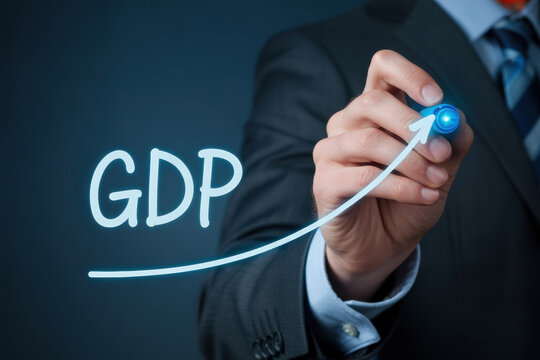 Businessman drawing an ascending glowing gdp line chart demonstrating economic progress and market expansion