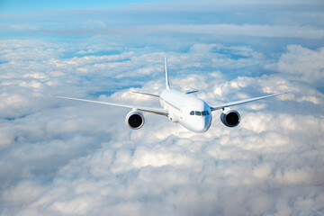 White passenger airplane flying in the sky amazing clouds in the background - Travel by air transport