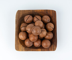 Macadamia nuts isolated. Natural raw peeled macadamia seeds and shells