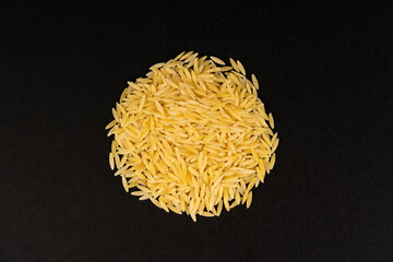 Raw orzo pasta, risoni or kritharaki pile