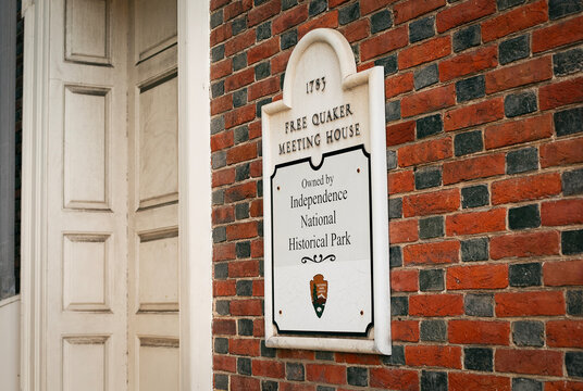 A plaque hangs on a brick wall marking the Quaker Meeting House, built in 1793. It belongs to Independence National Historical Park in Philadelphia, Pennsylvania, USA, July 7, 2025.