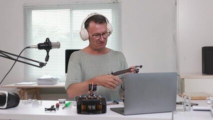 Male vlogger creating educational content about robotics