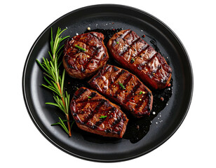 Black plate with four grilled steaks and rosemary garnish