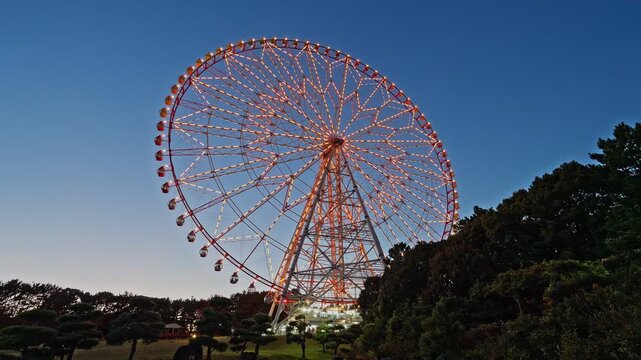 The iconic Diamond and Flower Ferris Wheel in Kasai Rinkai Park, Tokyo, illuminated against the beautiful twilight sky.