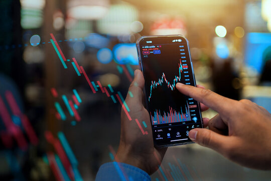 A person is looking at a stock market graph on their phone