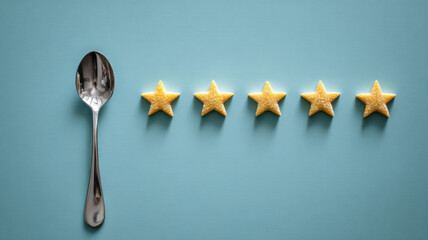 A silver spoon and five golden stars lay on the blue background to show good rating or quality